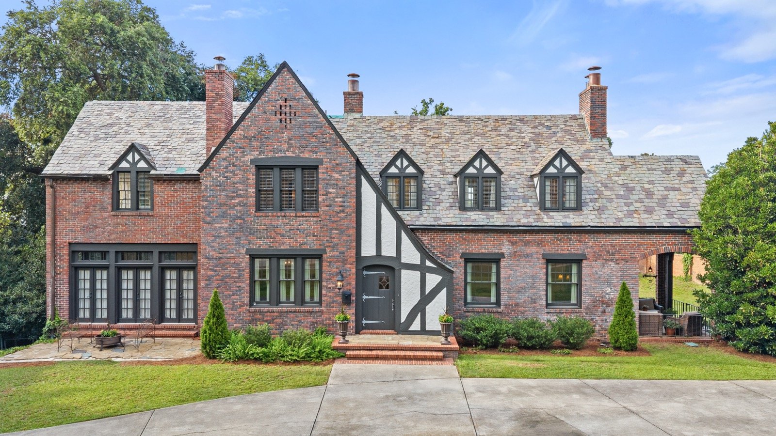 Daytime exterior photo of a brick Tudor home, Athens GA